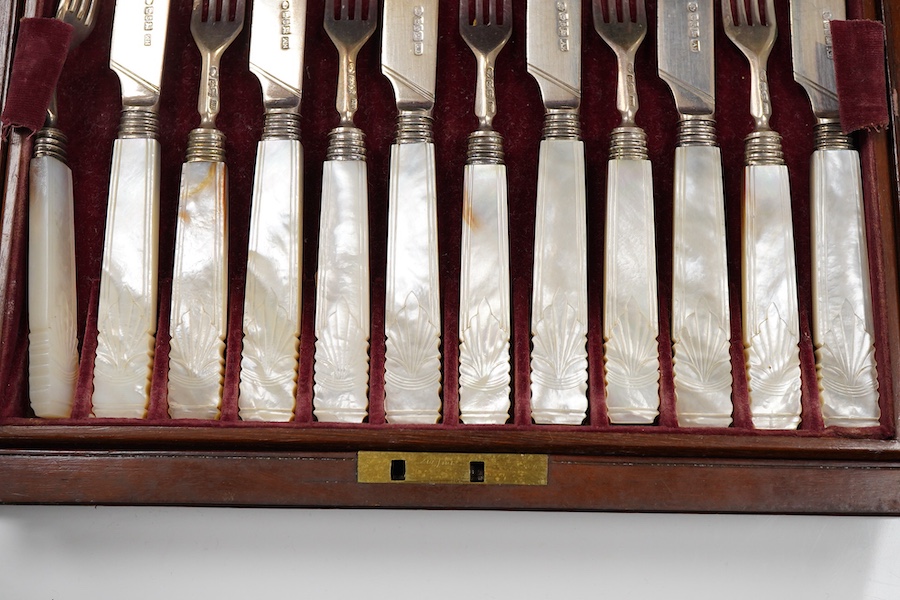 A set of twelve pairs of early Victorian mother of pearl handled dessert eaters, by Aaron Hadfield & Sons, Sheffield, 1838, no date letter on the forks, knife 19.1cm, housed in a mahogany canteen.